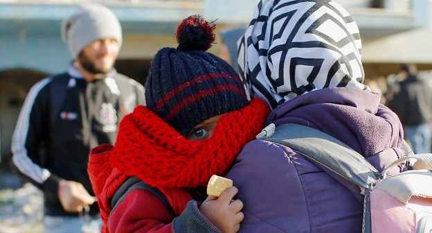 Женщина с ребенком, сбежавшие с территории вооруженного конфликта в Сирии. Фото: REUTERS/Huseyin Aldemir